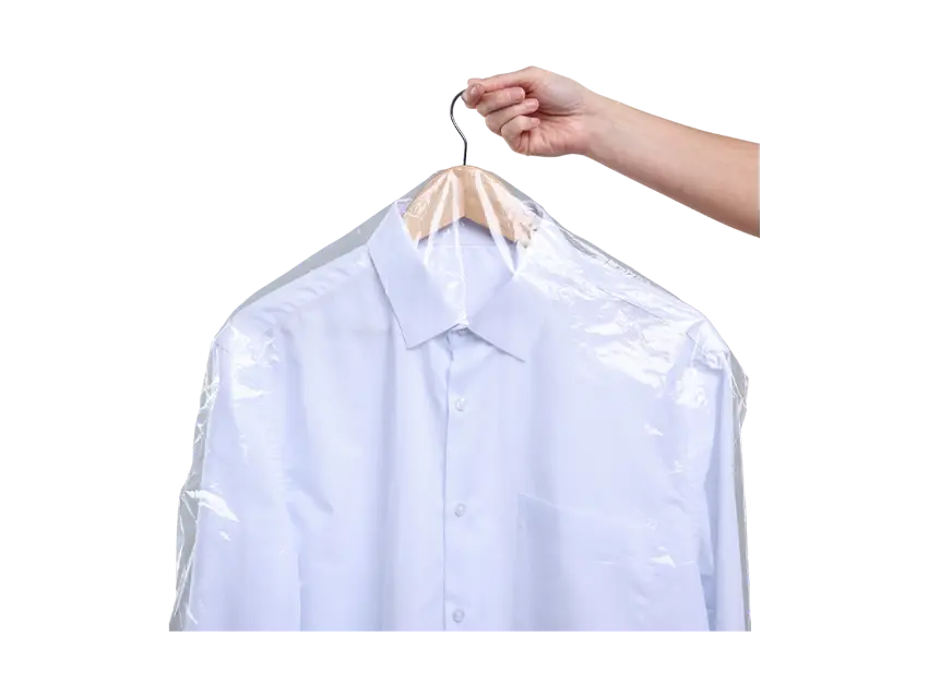 Hand holds a garment bag product over a white shirt on a hanger, Kleiderschutzhüllen, packaging.